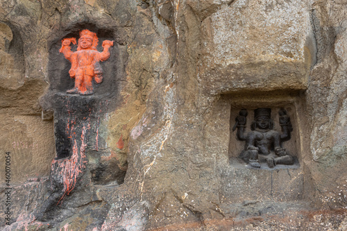 Carved statues of Gods on the rock of Mangi Tungi hills. Nashik, Maharashtra, India. photo