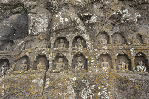Carved idols of Digambar Jain Tirthankaras on the rock of Mangi Tungi, Nashik, Maharashtra, India. photo