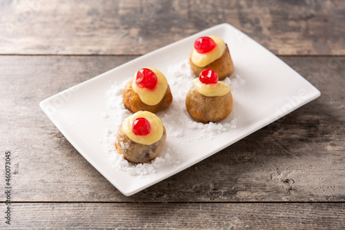 Traditional Italian Zeppole pastry on wooden table