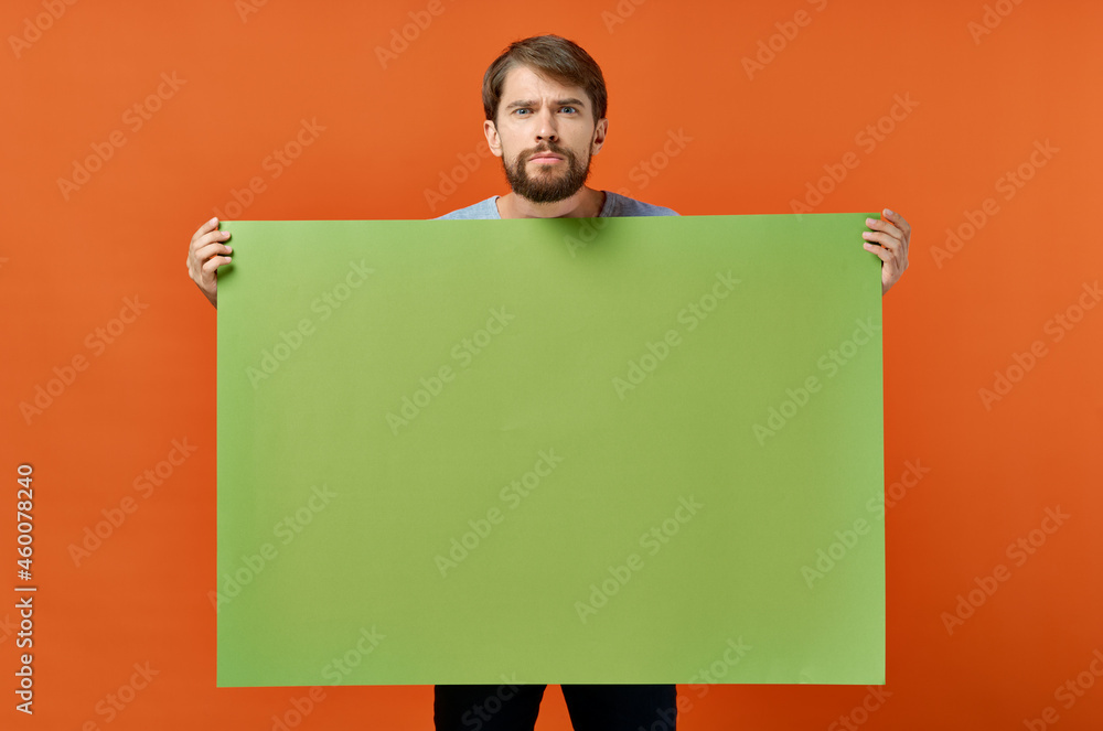 emotional man holding a green banner design studio lifestyle emotional man holding a green banner design studio lifestyle
