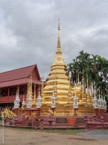 Vertical landscape view of beautiful golden stupa at ancient landmark Wat Phan Tao buddhist temple, Chiang Mai, Thailand