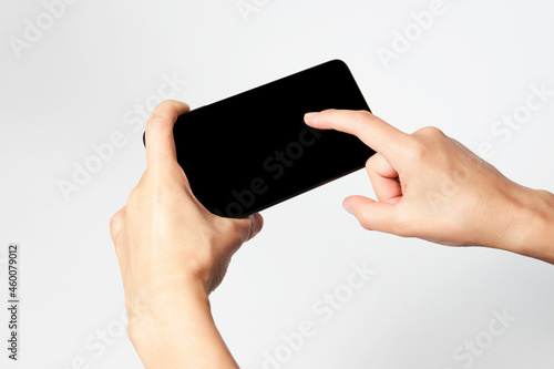 Woman holding smartphone with black screen