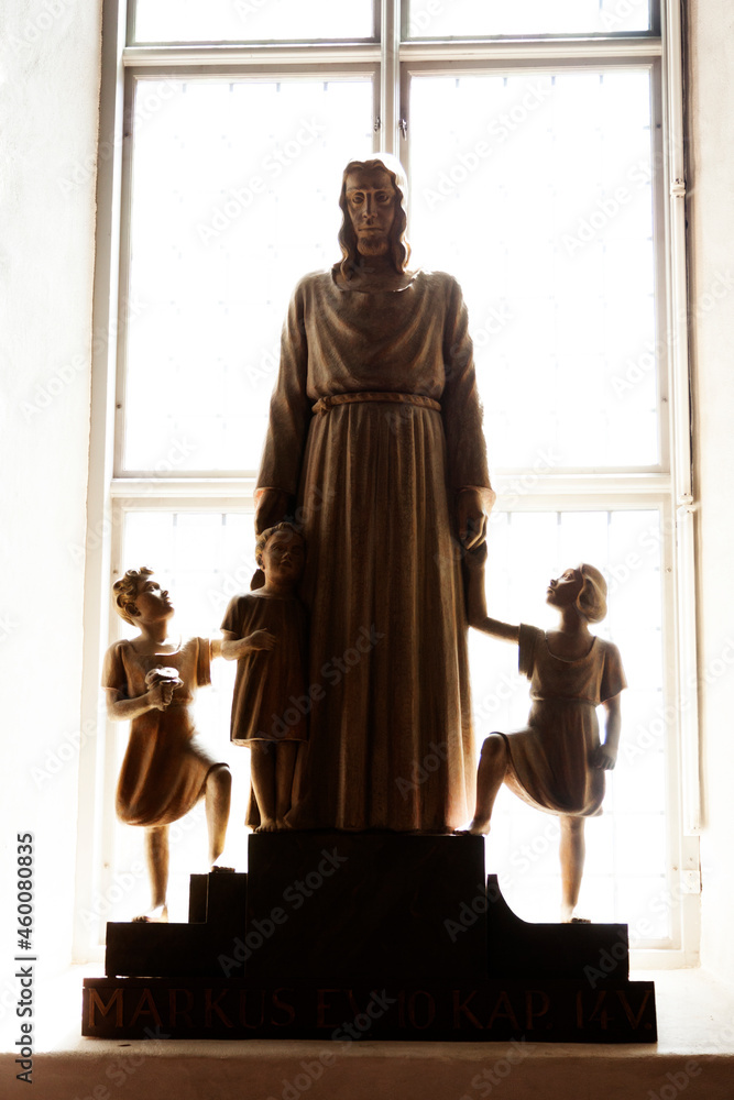 Nordmaling, Norrland Sweden - June 10, 2021: a statue of Jesus with children in backlight