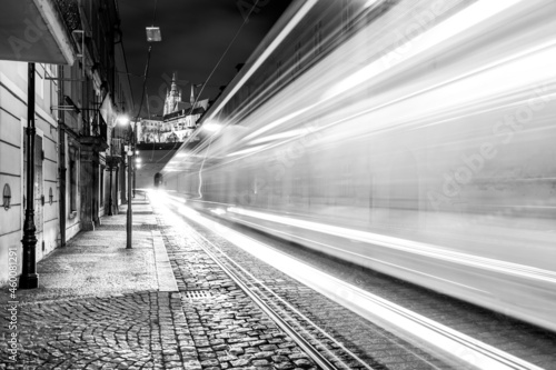 Night tram in Prague. Motion blurred tram in Letenska Street, Lesser Town of Prague, Czech Republic. Black and white image.
