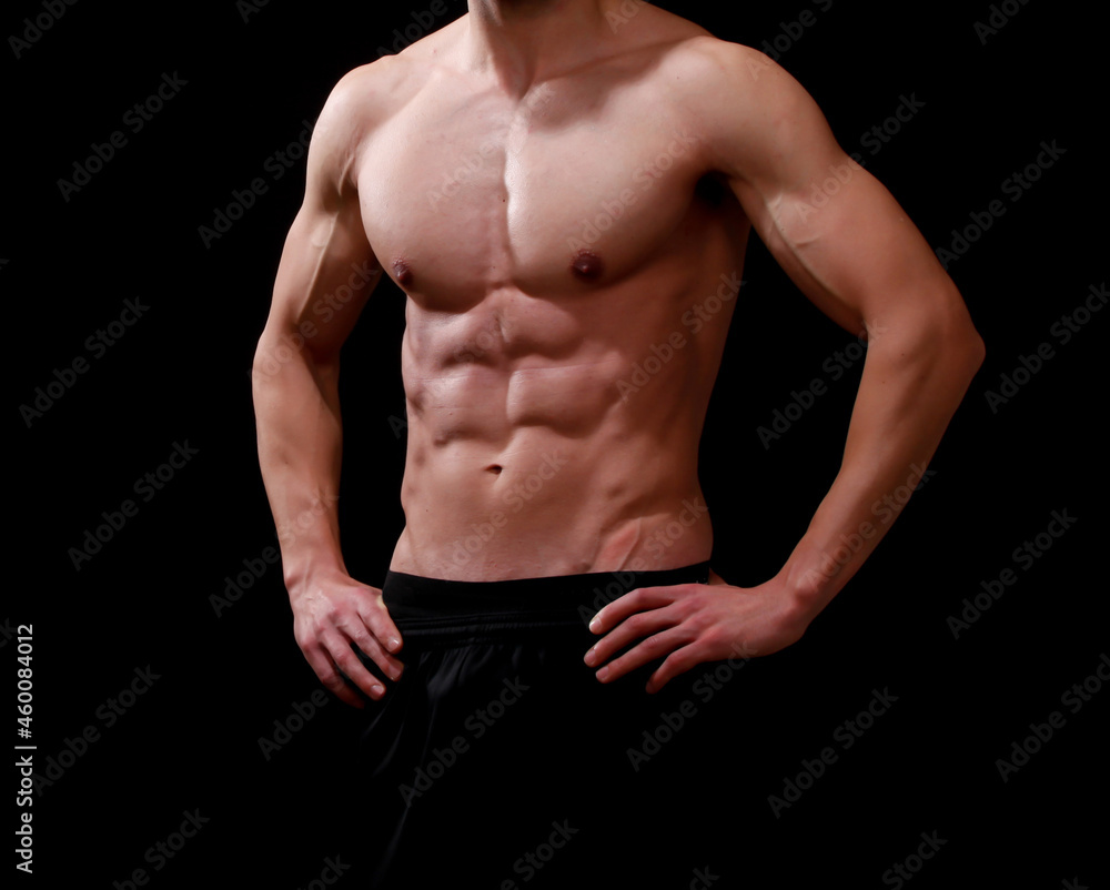 Muscular male torso - isolated fitness body of men black background Muscular male torso - isolated fitness body of men black background