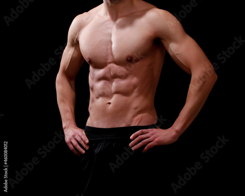 Muscular male torso - isolated fitness body of men black background