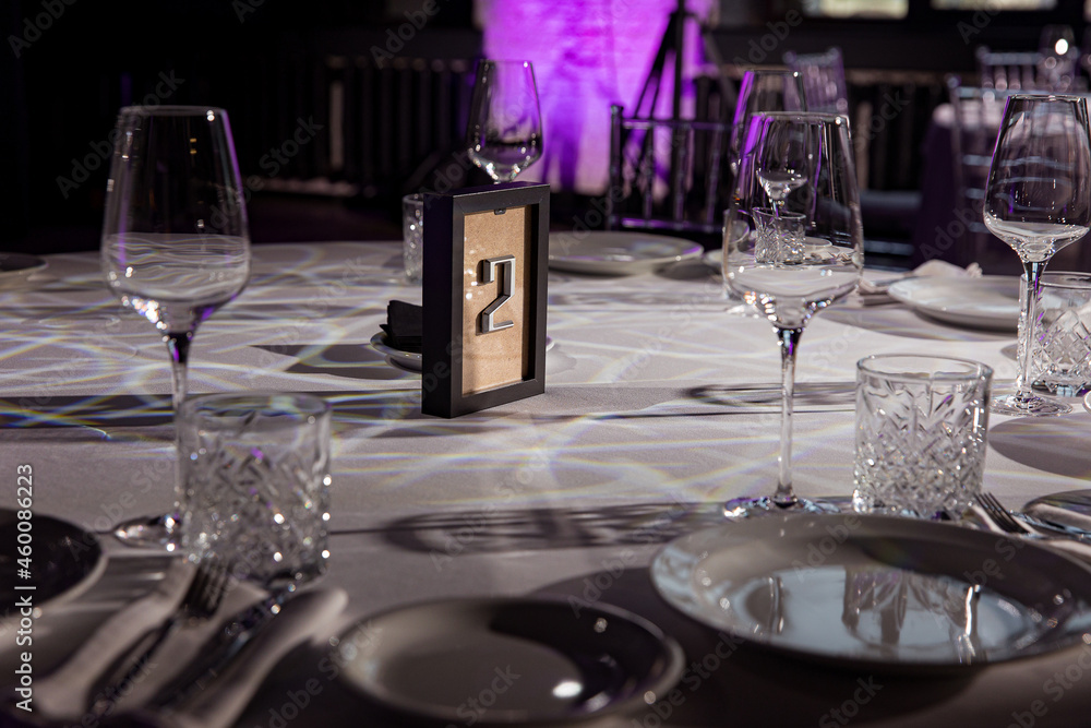 stylish empty glasses and plates at setting at elegant table for wedding reception, catering in restaurant stylish empty glasses and plates at setting at elegant table for wedding reception, catering in restaurant