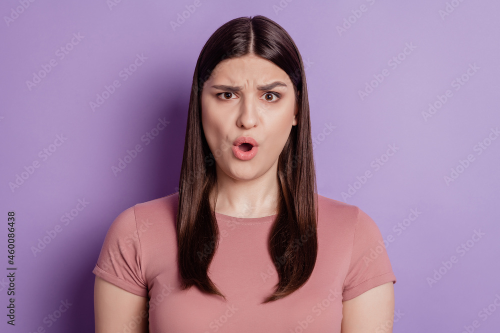 Fototapeta premium Portrait of impressed angry mad amazed shocked brunette girl open mouth isolated on violet background