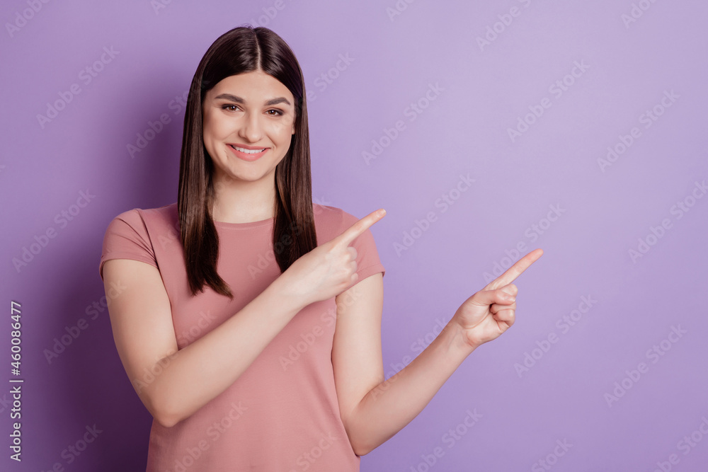 Portrait of positive cheerful girl point index finger copyspace advert advice choice suggest promo isolated over violet color background Portrait of positive cheerful girl point index finger copyspace advert advice choice suggest promo isolated over violet color background