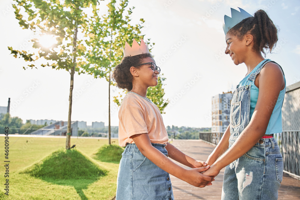Little black girls in paper crowns holding hands Stock Photo | Adobe Stock