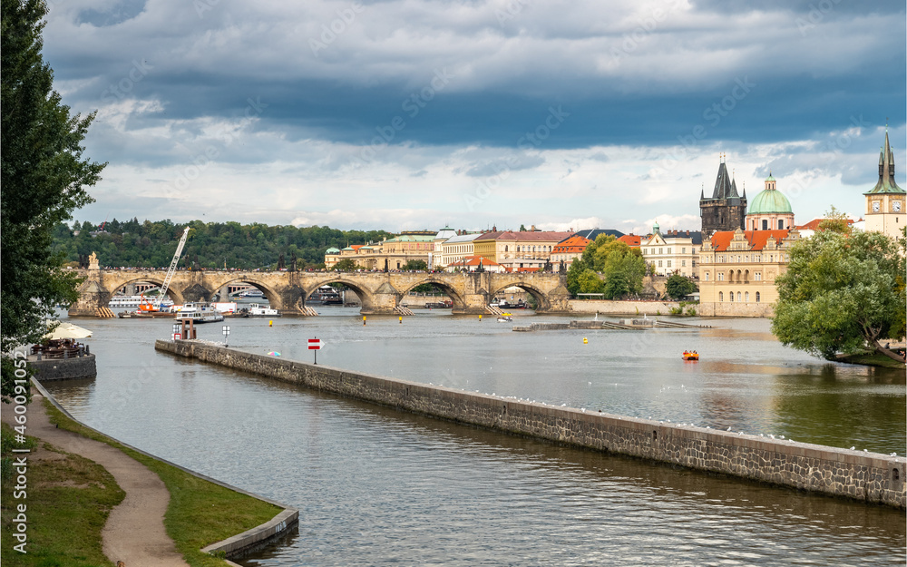 Fototapeta premium Prague, Czech Republic. A view over the Vlatava River with the landmark Charles Bridge and Old Town Bridge Tower in the distance.