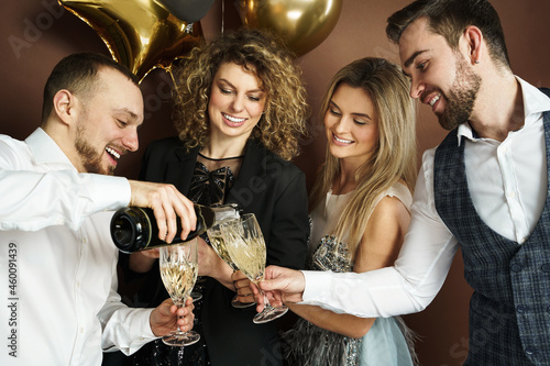 Photography Well dressed party people celebrating  holiday or event and drinking sparkling w