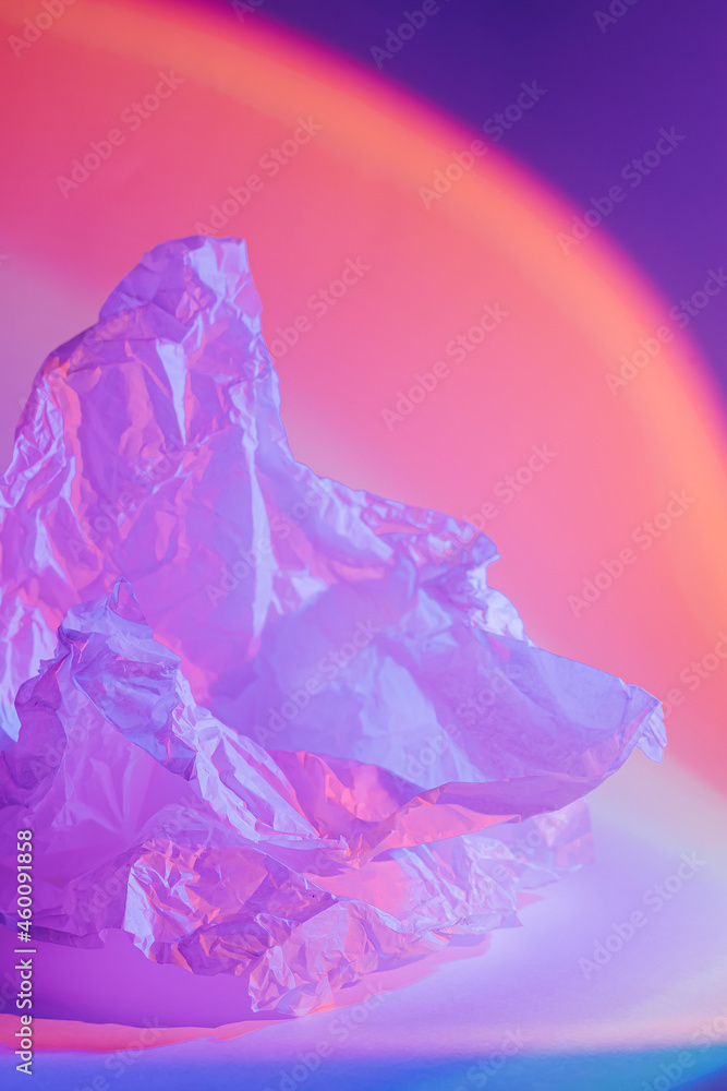 Abstract background with crumpled paper in neon light. Abstract background with crumpled paper in neon light.