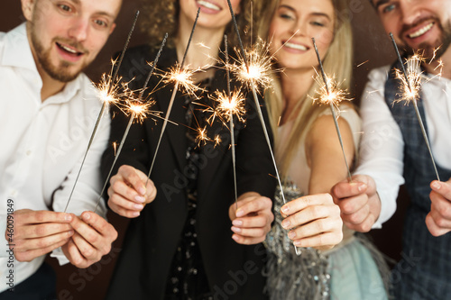 Party people with bruning sparklers celebrating  holiday or event photo