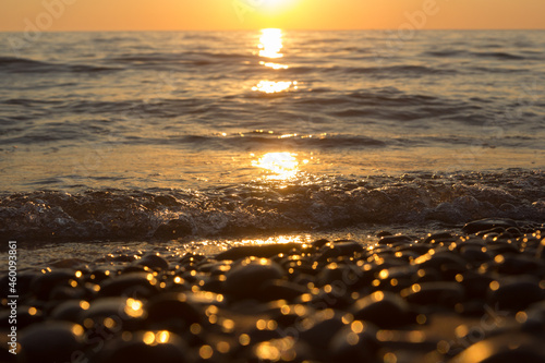 sunset in Baltic Sea with sun shining stones