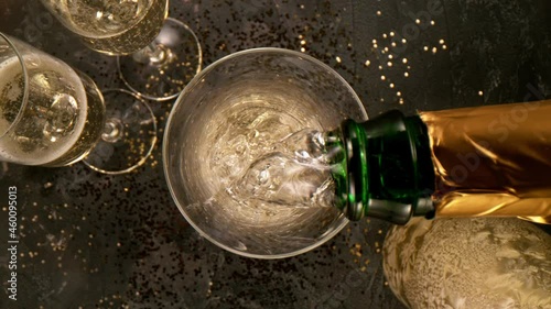 Super slow motion of pouring champagne into glass with camera motion. Filmed on high speed cinema camera, 1000 fps. photo
