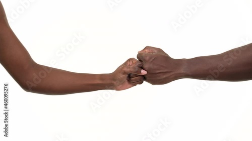 Close up of a black man and black woman shaking hands, giving dignity and pride. Isolated on a white background.
