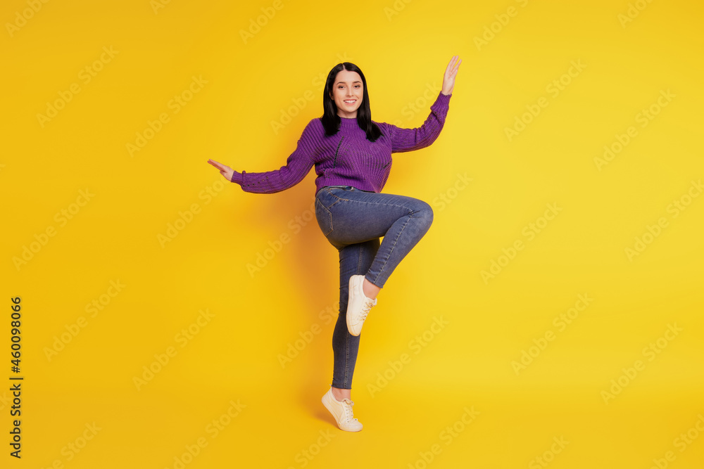 Obraz premium Full length body size view of nice attractive cheerful girl having fun fooling isolated on yellow color background