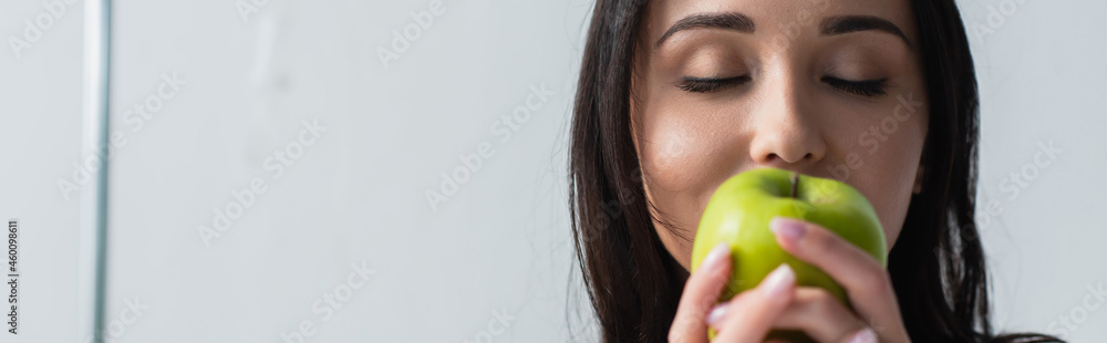 brunette woman holding fresh apple in hands, banner brunette woman holding fresh apple in hands, banner