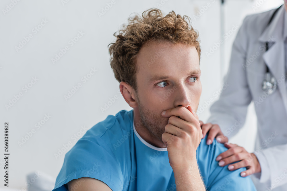 doctor in white coat calming sick and scared patient in hospital doctor in white coat calming sick and scared patient in hospital