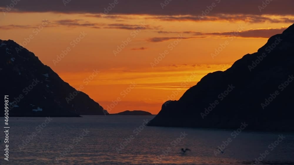 View of picturesque peaceful seascape during sunrise in Barents sea, seagulls soaring above sea next to fishing vessel, Slow motion View of picturesque peaceful seascape during sunrise in Barents sea, seagulls soaring above sea next to fishing vessel, Slow motion