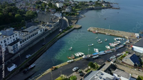 Bullock Harbour, Dalkey, Dublin, Ireland, September 2021. Drone gradually orbits from the south while descending east towards the quay with Sandycove in the background. photo