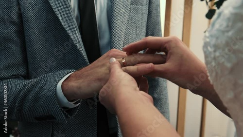 The bride puts the wedding ring on the groom's finger. wedding hands with rings. The bride and groom exchange wedding rings. High quality 4k footage