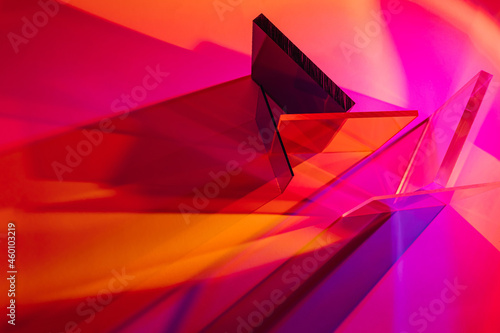 Multicolored glass on colorful gradient background. The light travels through different acrylic sheets. Stylish abstract background photo