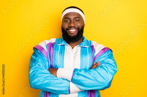 Photo of young afro man happy positive smile crossed hands confident sportive isolated over yellow color background