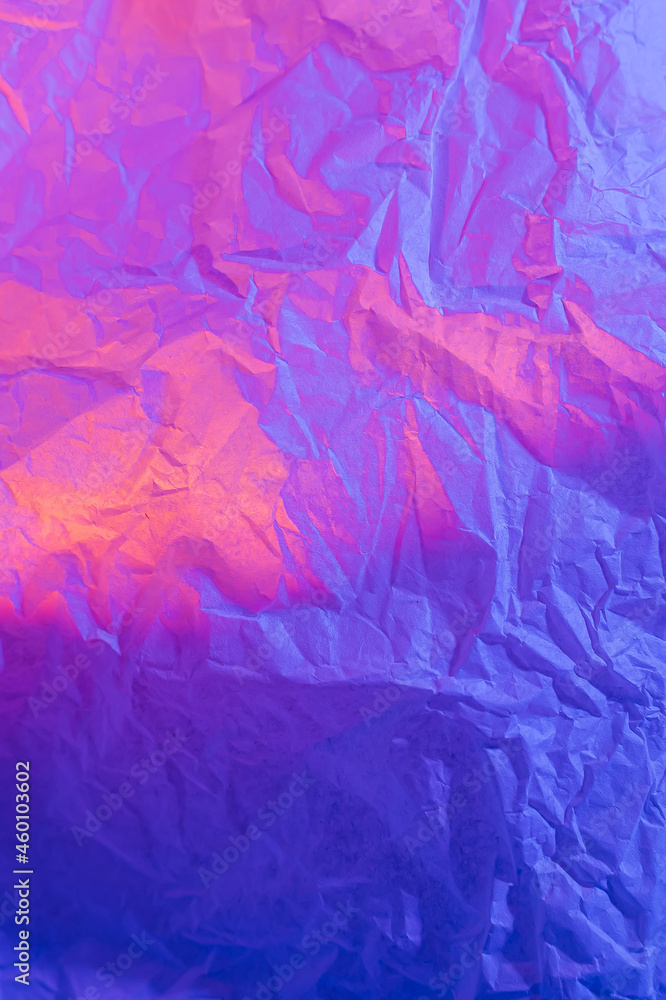 Abstract background with crumpled paper in neon gradient. Vivid blue, pink and orange colors