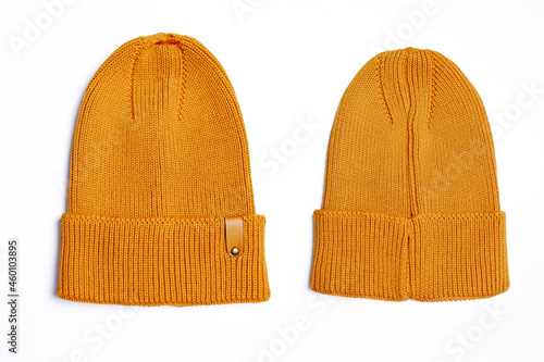 Knitted jersey hat in mustard color (front view, back view) on a white background. Comfortable autumn, winter clothes for shopping, sales, promotion, style in the concept of fashionable colors.