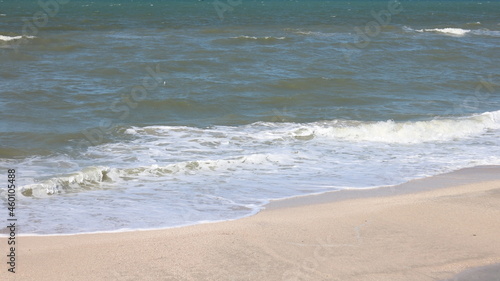 Beautiful seascape with beautiful sea waves and sea foam on shore with sea water on beach by sea