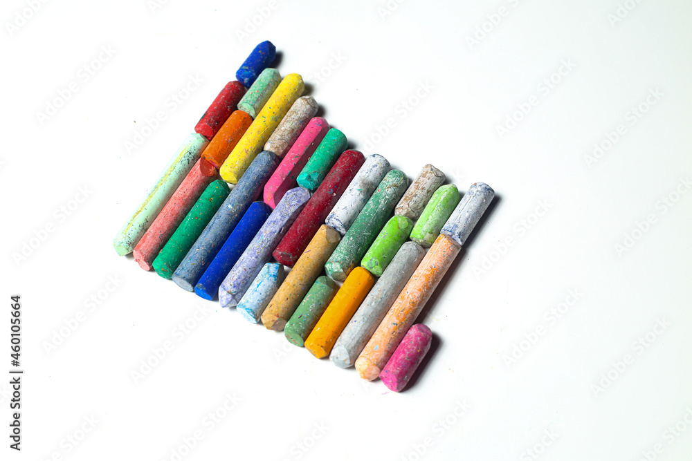 chalks in a variety of colors arranged on a white background chalks in a variety of colors arranged on a white background