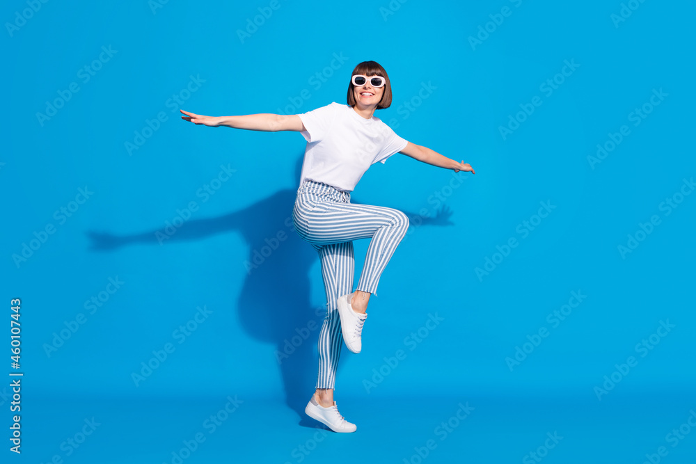 Full length body size photo careless girl in sunglass dancing in casual clothes isolated bright blue color background