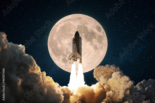 Fototapeta Naklejka Na Ścianę i Meble -  New space rocket with smoke and clouds takes off into the sky with full moon. Shuttle spaceship liftoff. Space Mission Launch Concept.