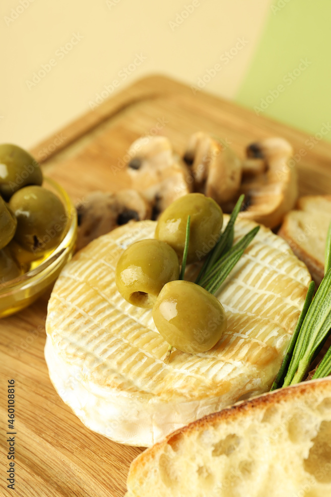 Concept of tasty food with grilled camembert on two tone background Concept of tasty food with grilled camembert on two tone background