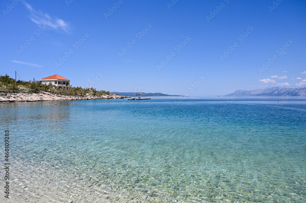 Sea and beach at summer. Soft sea waves on beautiful sandy beach. Vacation, travel and tourism  concept. 