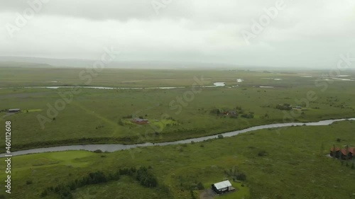 aerial drone footage of the country side of southerner Iceland during the later summer months.  the beautiful greens landscape is filled with farms animals grazing on the pasture