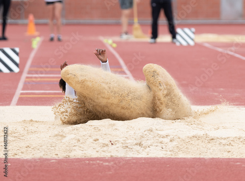 Long jumpers competing at a track and field meet photo