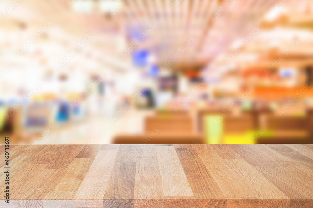 Brown empty wooden table top in front of blurred background. Light wood with blurry in restaurant interior. Can be used for display or montage your products. Mock up for display or product.
