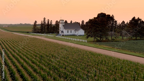 Aerial view of corn crop in South Dakota with small country church in the background at sunset photo