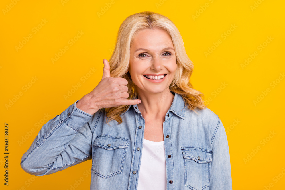 Photo of charming positive old woman hands call operator good mood smile isolated on yellow color background Photo of charming positive old woman hands call operator good mood smile isolated on yellow color background