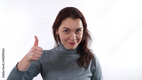 Wallpaper Mural Beautiful woman 30-35 years old brunette shows OK signal, thumb up. Thumb up gesture. White background. Torontodigital.ca