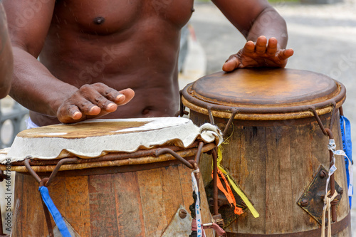 Musician playing atabaque which is a percussion instrument of African origin used in samba, capoeira, umbanda, candomble and various cultural, artistic and religious manifestations in Brazil photo