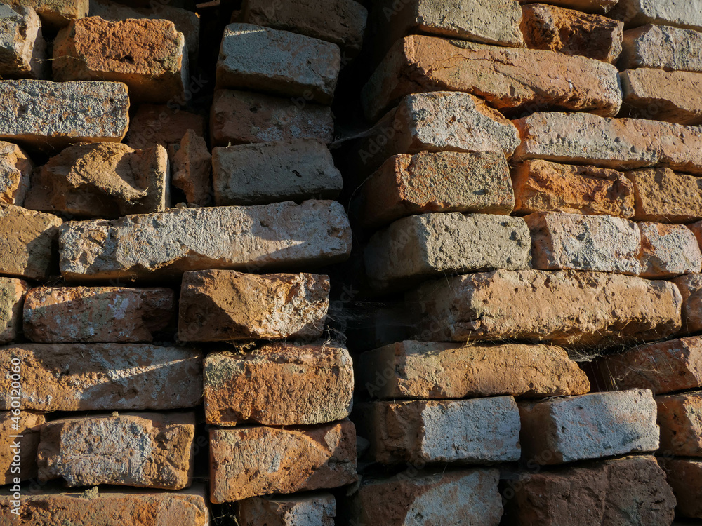 Old used construction bricks in a big stack , harsh sunlight, image for industrial background. Old used construction bricks in a big stack , harsh sunlight, image for industrial background.