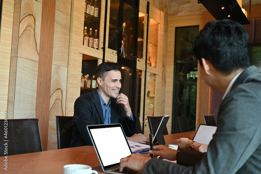 Photo of a board of directors of a liquor company discussing at a conference table over a modern and luxury meeting room as a background. Photo of a board of directors of a liquor company discussing at a conference table over a modern and luxury meeting room as a background.
