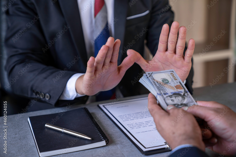 An honest businessman or politician refuses to accept bribes that are