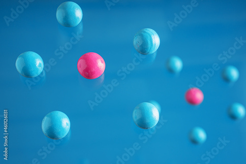Blue and pink balls flowing upwards on blue background. .Abstract background with bright balls.