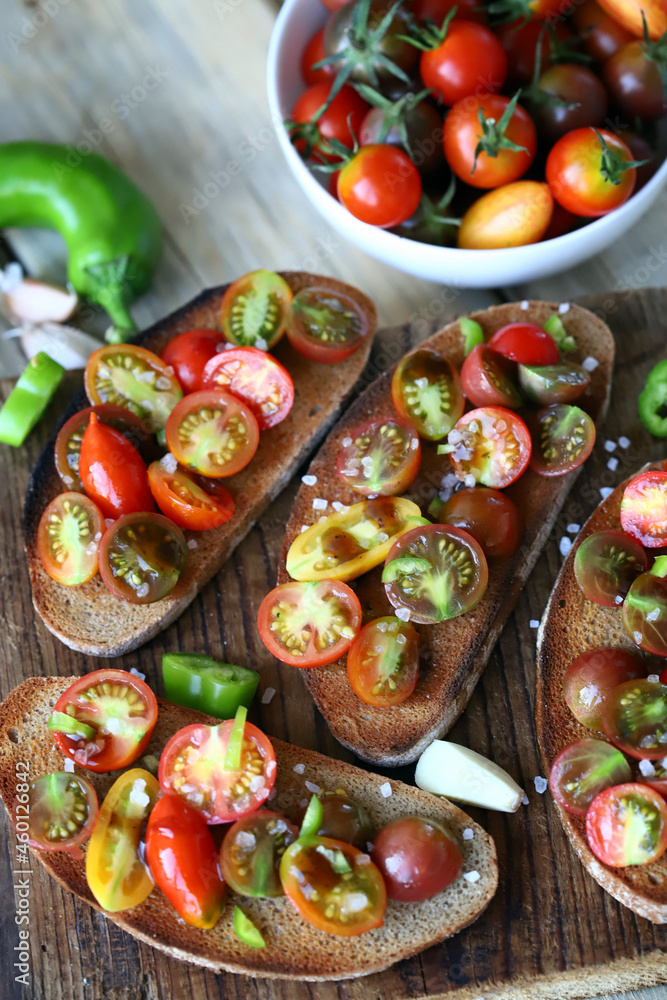 Croutons with cherry tomatoes, garlic and hot peppers. Healthy bruschetta with tomatoes. Croutons with cherry tomatoes, garlic and hot peppers. Healthy bruschetta with tomatoes.