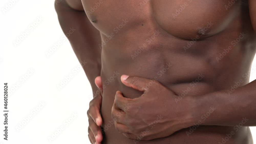 Close up of a black man massaging his stomach. Isolated on a white background. Close up of a black man massaging his stomach. Isolated on a white background.
